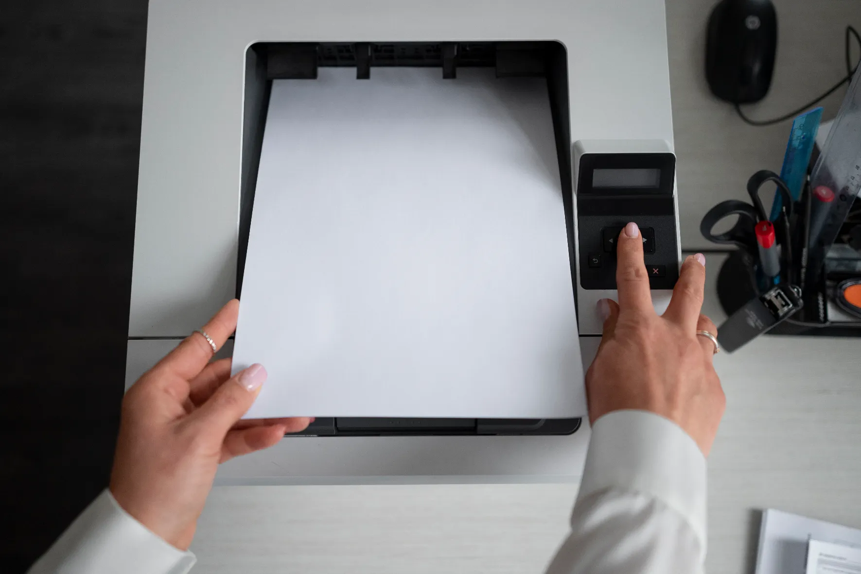 Woman using printer while working office